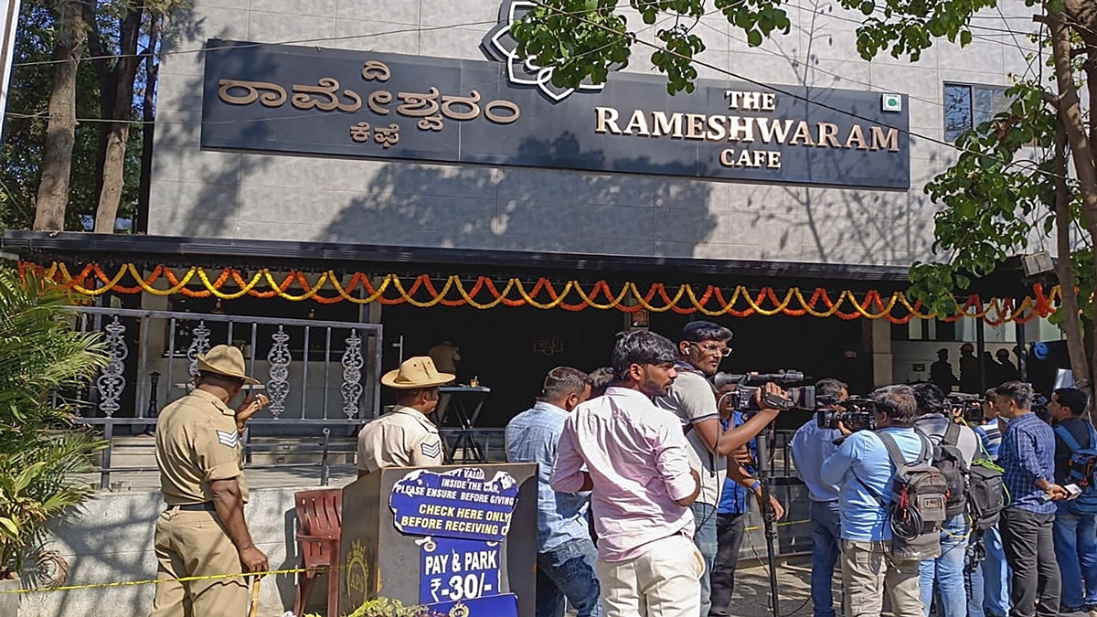 Security officials and others gather at bomb explosion site Rameshwaram Cafe.