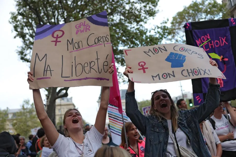 Women hold signs reading "My body, my freedom" and "my body my choice" during an abortion rights